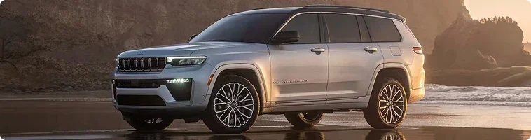 2026 Jeep Grand Cherokee towing a trailer compared with the Ford Explorer