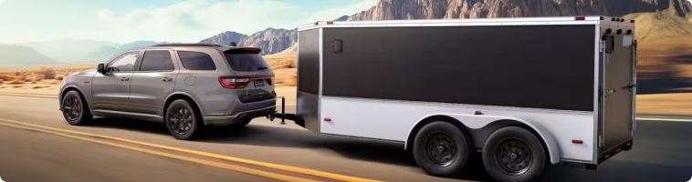 2026 Dodge Durango towing a trailer compared with the Chevrolet Tahoe