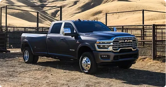 Grey 2026 Ram 3500 Heavy Duty dually parked beside a livestock pen